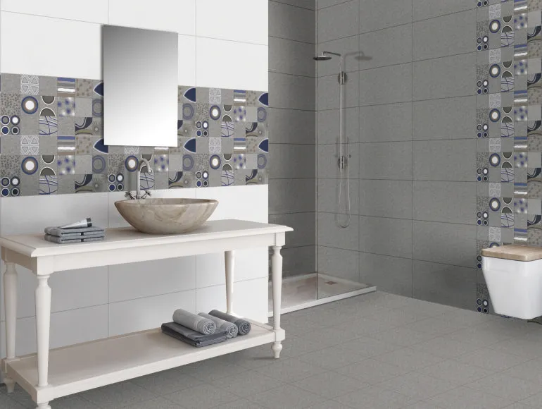 Grey bathroom design with a modern countertop sink, mirror and western toilet